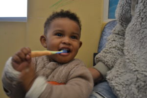 toddler chewing toothbrush